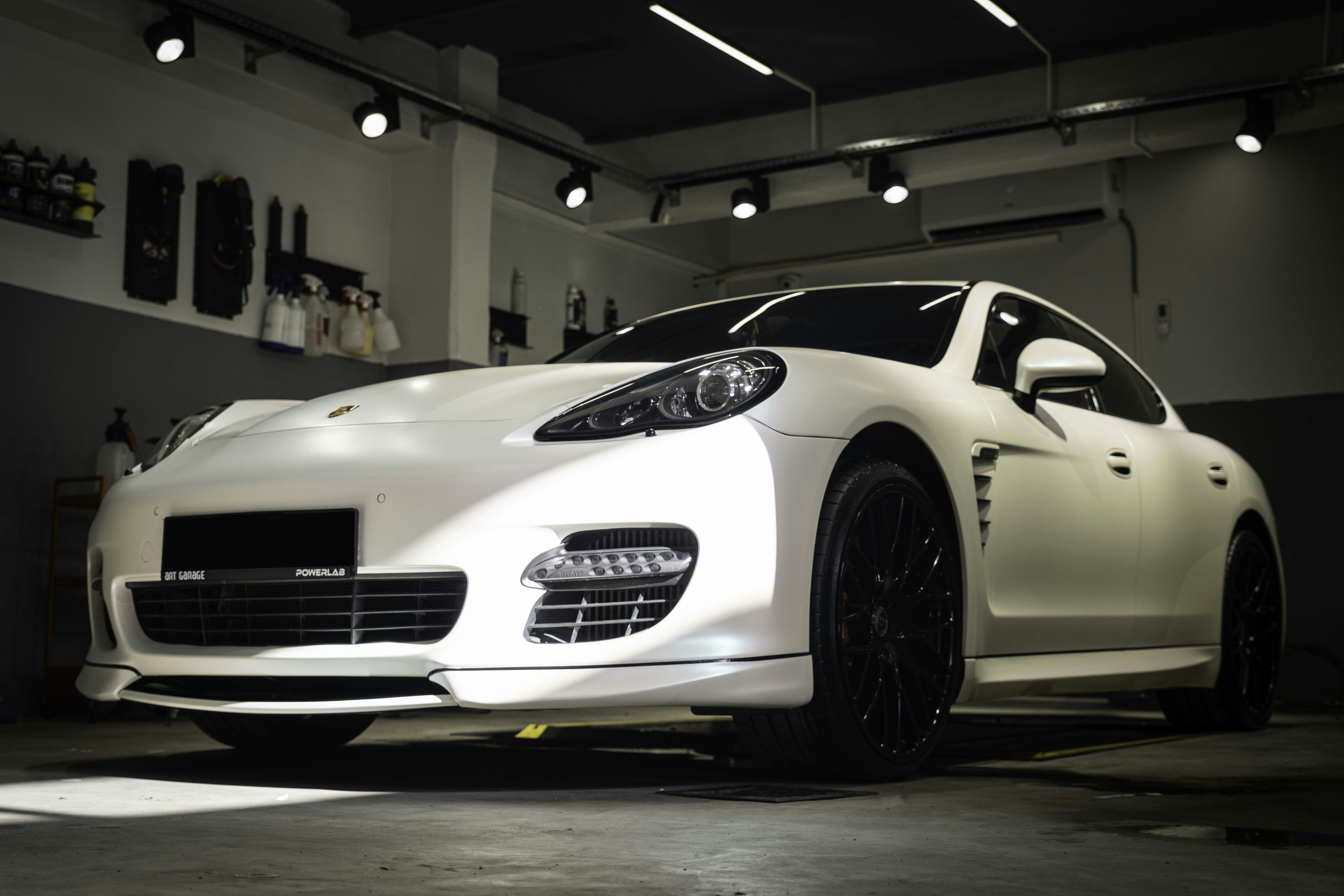 a white sports car parked in a garage