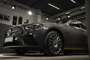 a car is parked in a garage with lights on