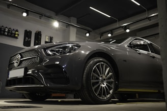 a car is parked in a garage with lights on