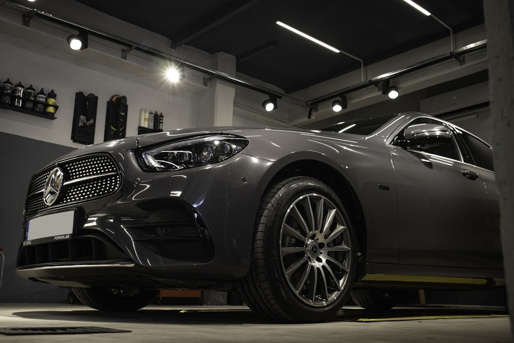 a car is parked in a garage with lights on