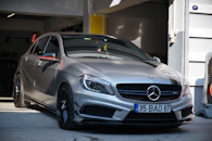 a silver mercedes cla parked in a garage