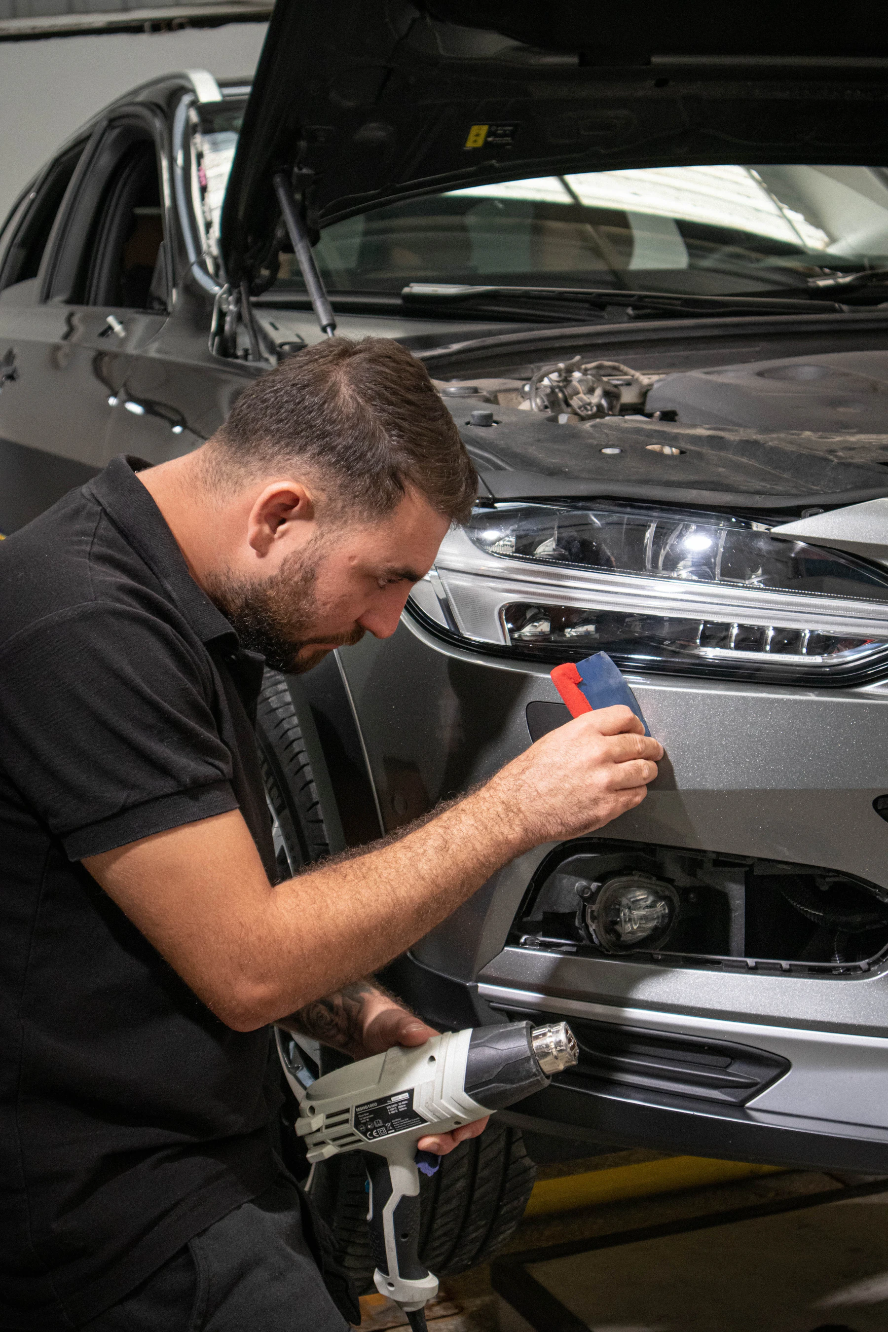 Technician working on a vehicle inside the Crystalline facility
