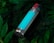 A metal water bottle with a turquoise stripe, featuring a red button on the cap, lies amidst lush, dark green foliage.