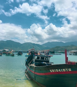 Colorful boats docked at Isla Mujeres with turquoise Caribbean sea in the background.
