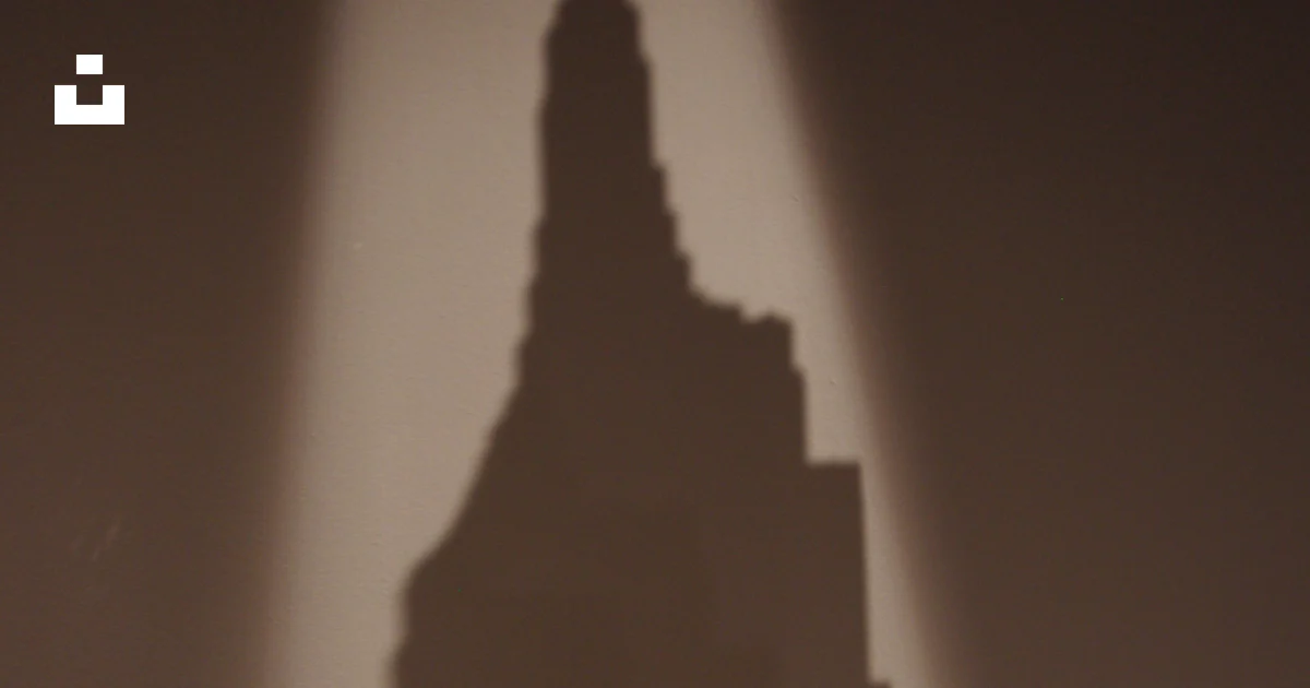 A shadow of a building on a wall photo – Free Building Image on Unsplash