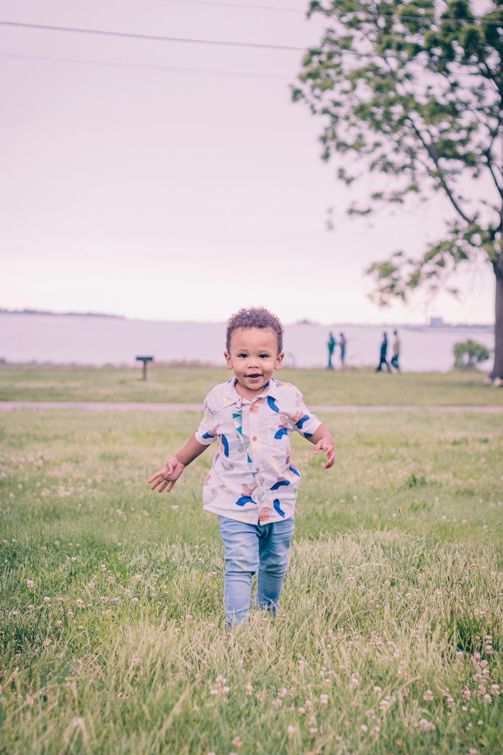 a little boy that is running in the grass