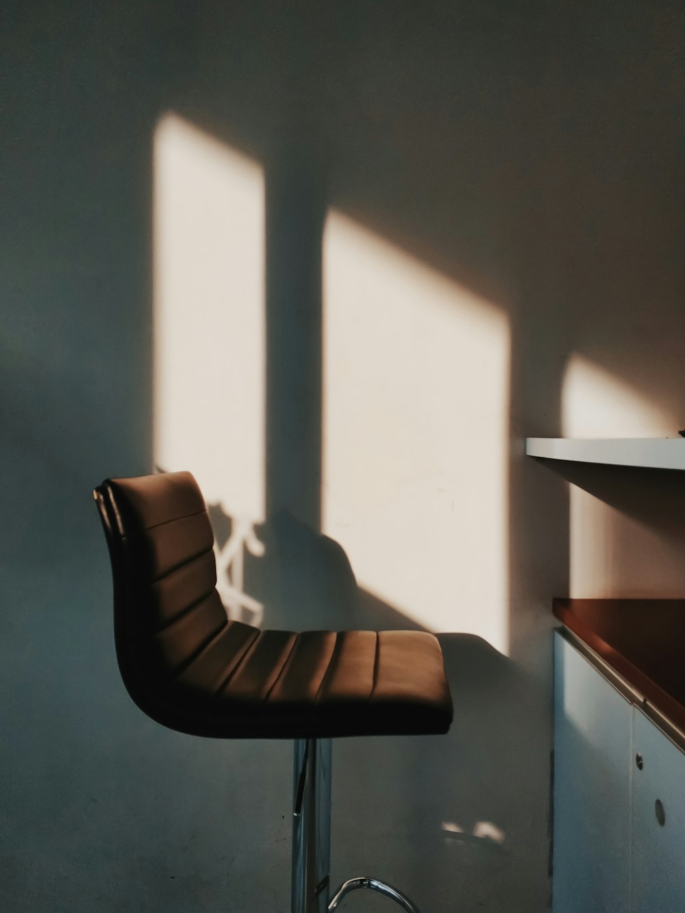 a chair sitting in a room next to a counter