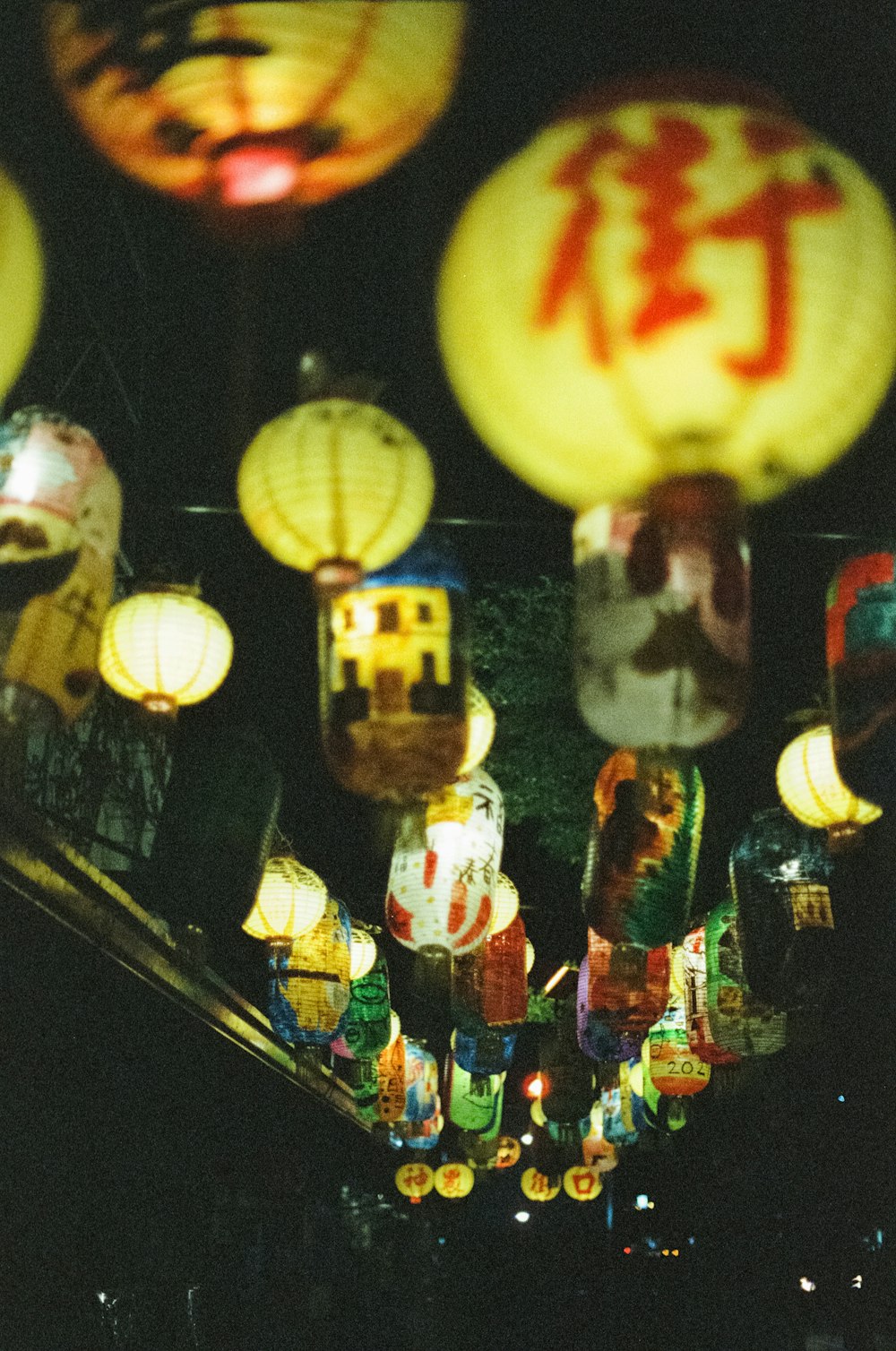 a group of paper lanterns hanging from a ceiling