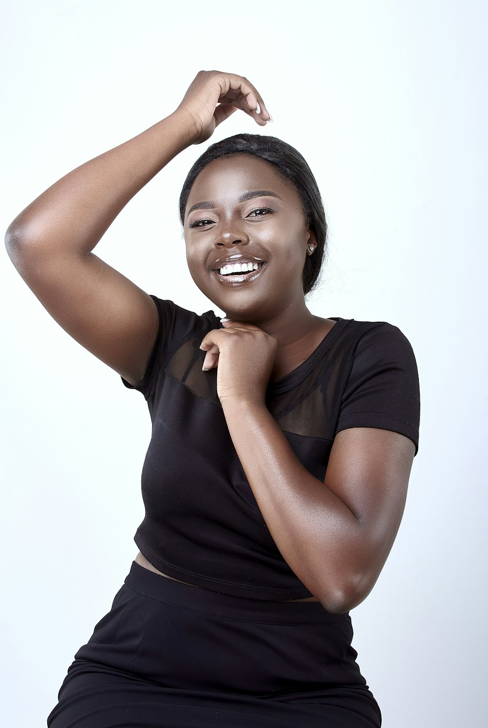 a woman posing for a picture in a black dress