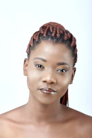 Soft natural light highlighting a variety of braided hairstyles styled with feminine elegance.