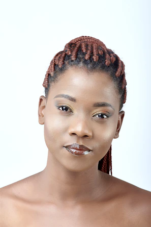 Soft natural light highlighting a variety of braided hairstyles styled with feminine elegance.