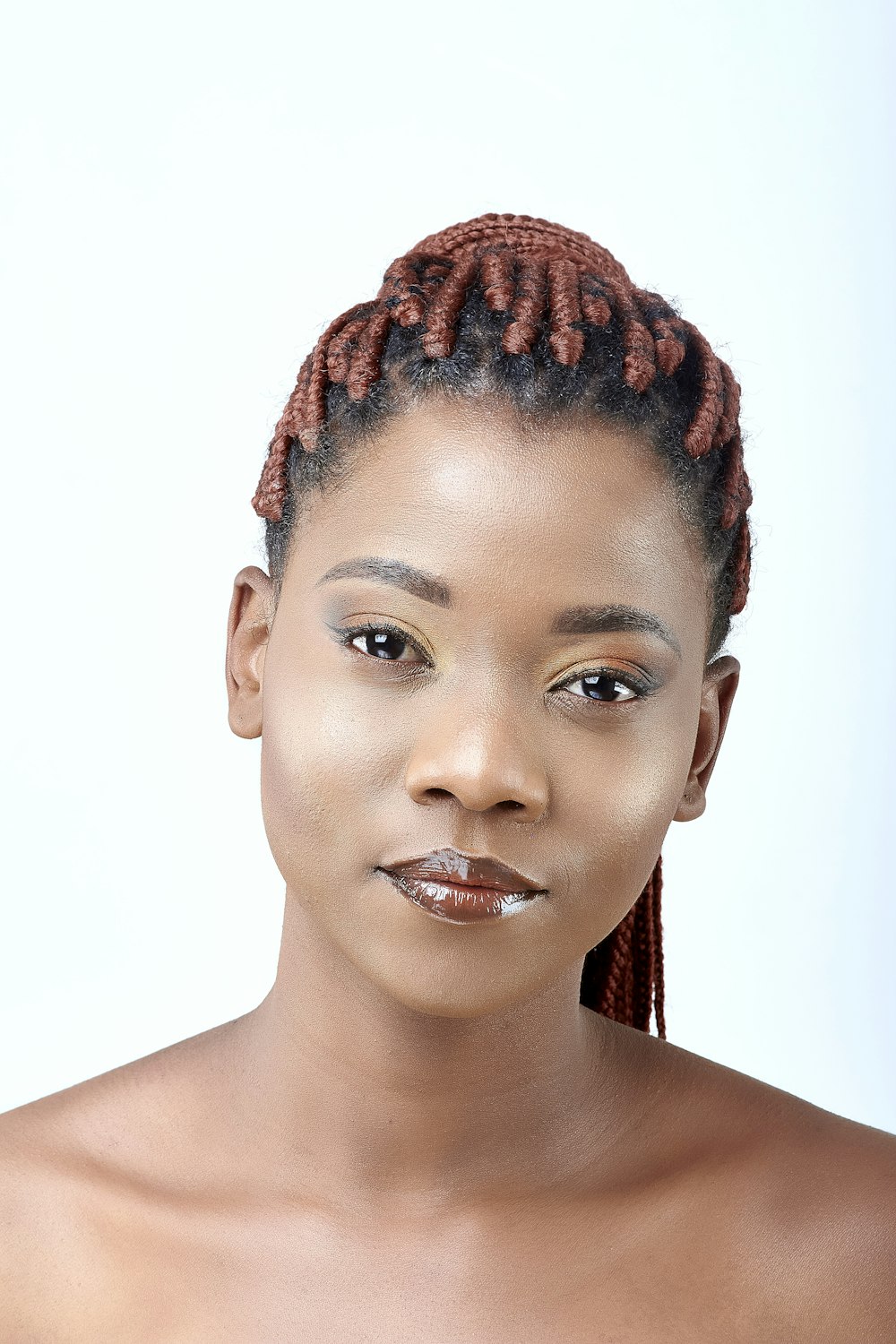 a woman with braids on her hair posing for a picture