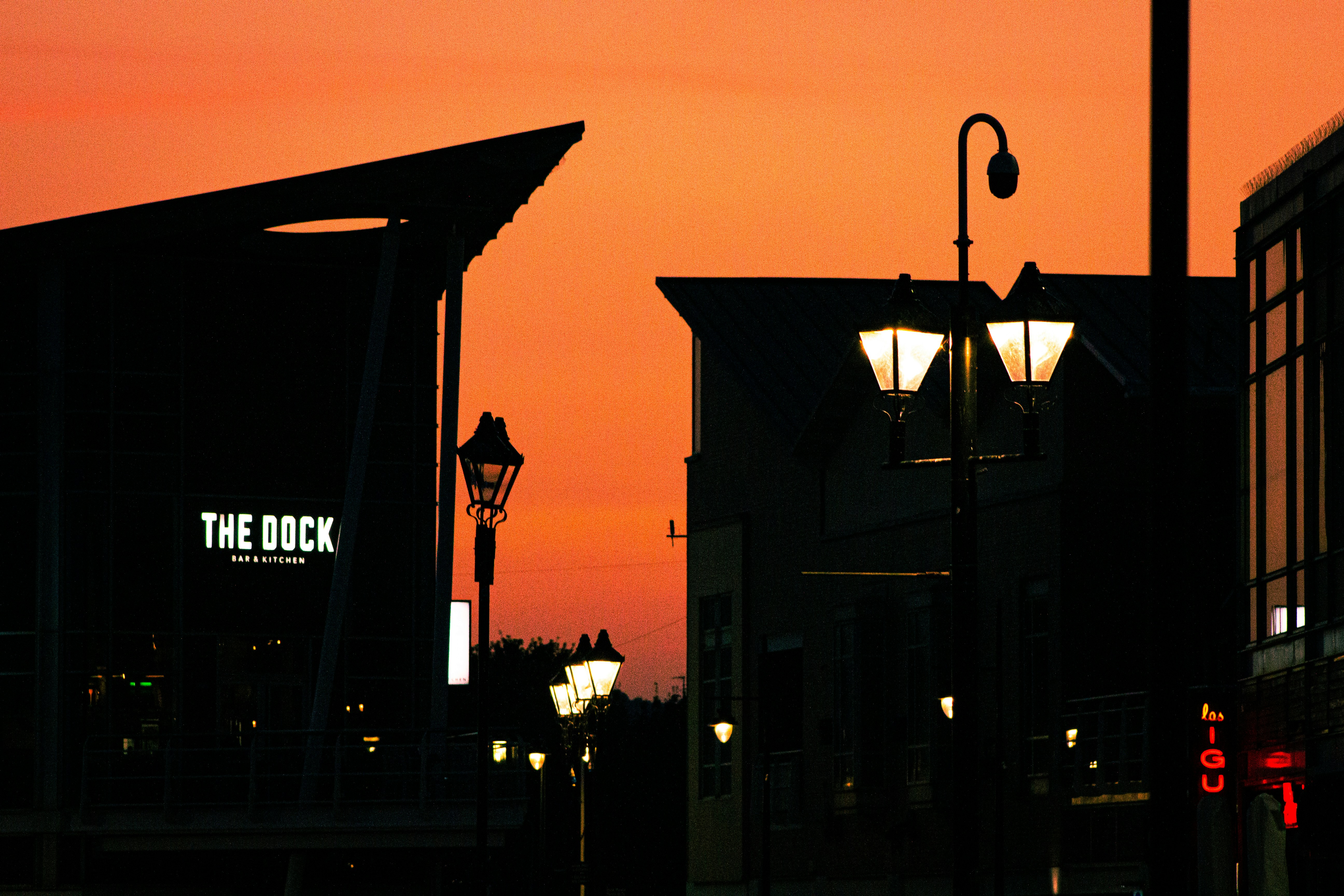 a street light sitting next to a tall building