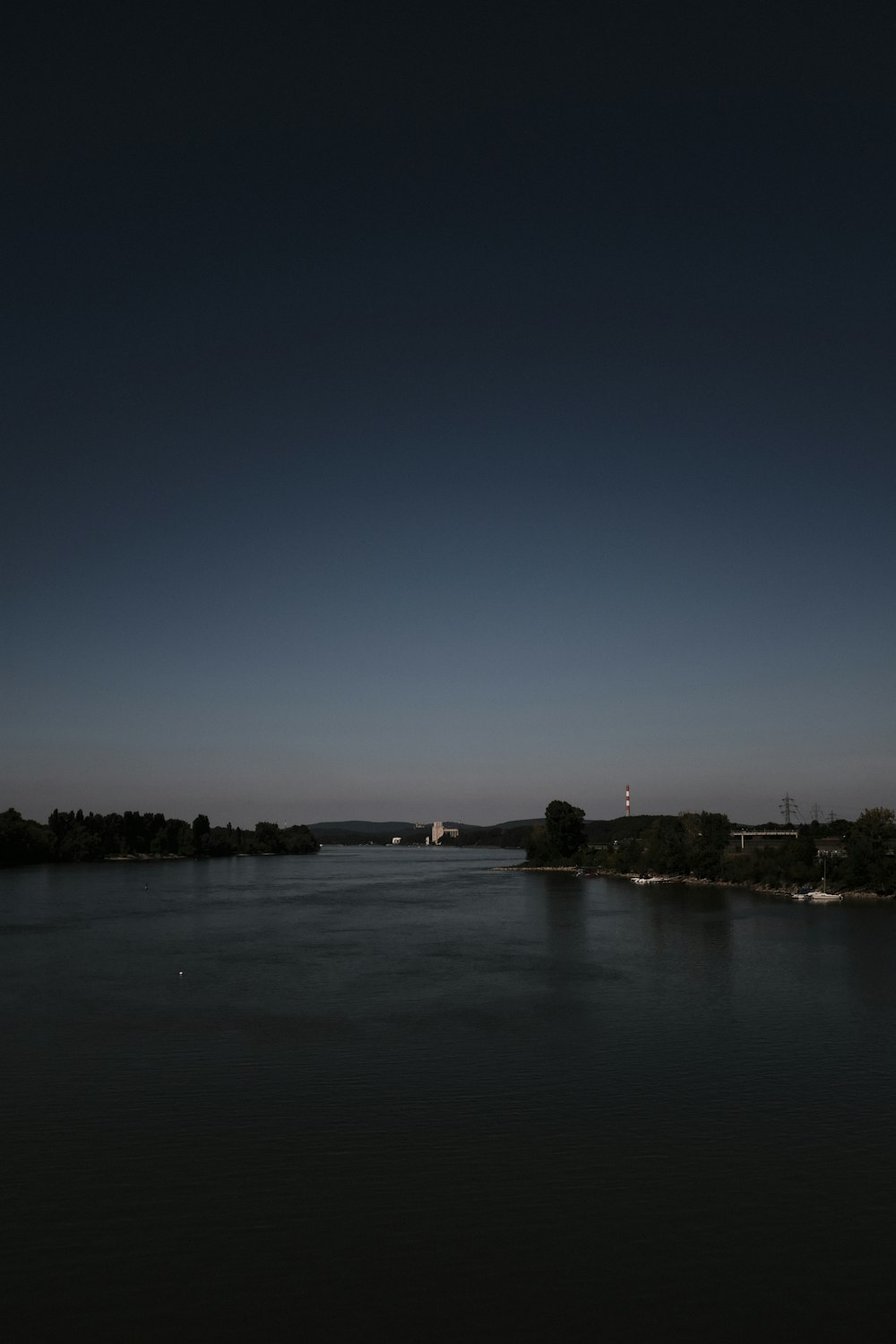 a body of water at night with a sky background