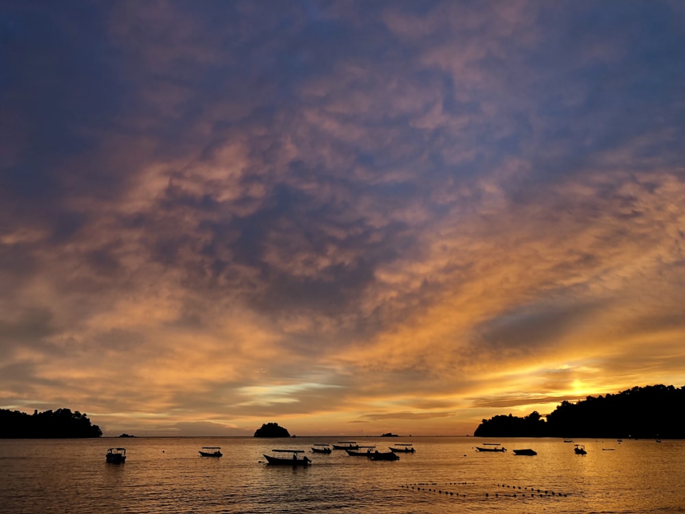 a group of boats floating on top of a body of water