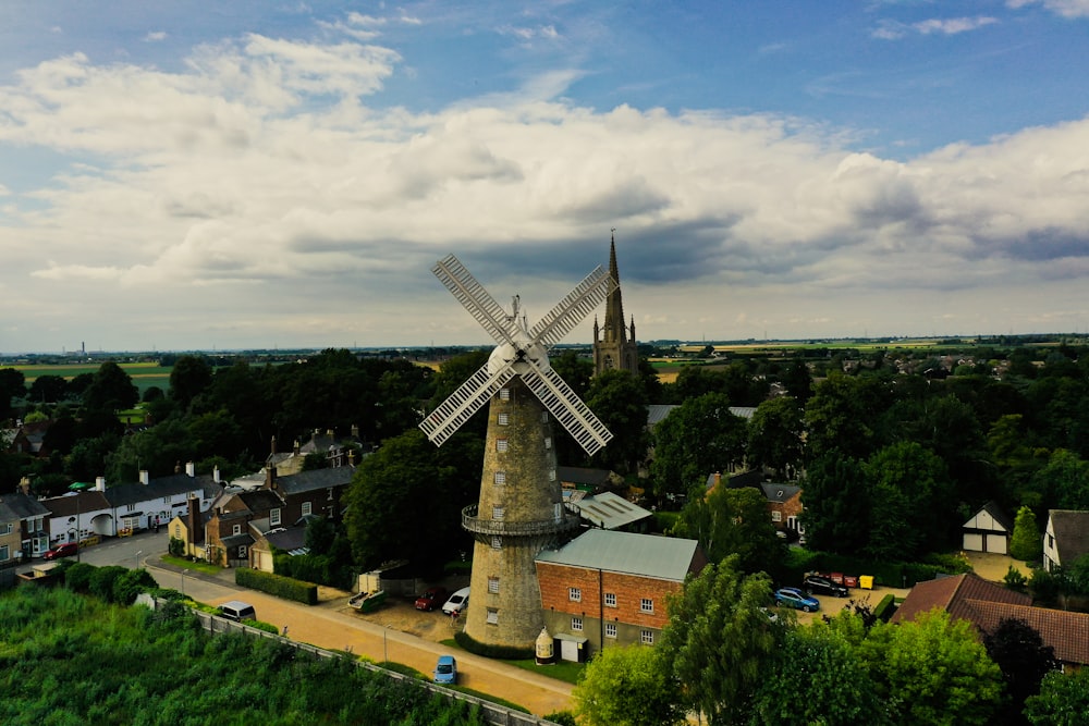 an aerial view of a windmill in a village
