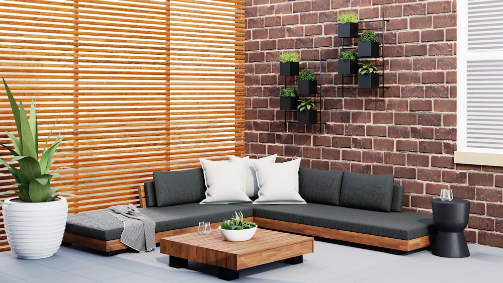 a living room with a couch, coffee table and potted plant