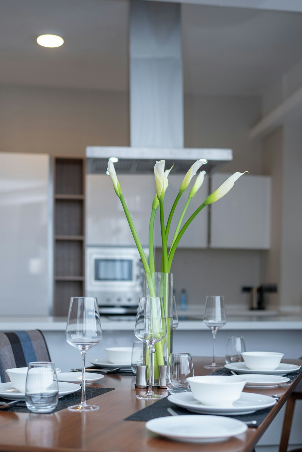 a dining room table with a vase of flowers on it