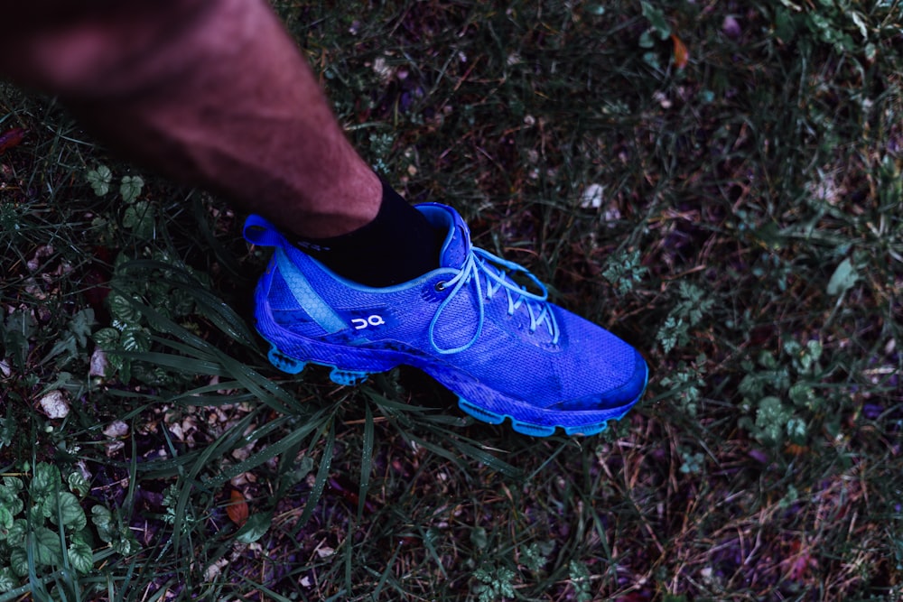 A person wearing blue shoes standing in the grass photo – Free Switzerland  Image on Unsplash