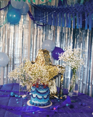a table with a cake and balloons on it