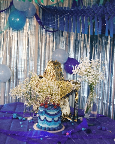 a table with a cake and balloons on it