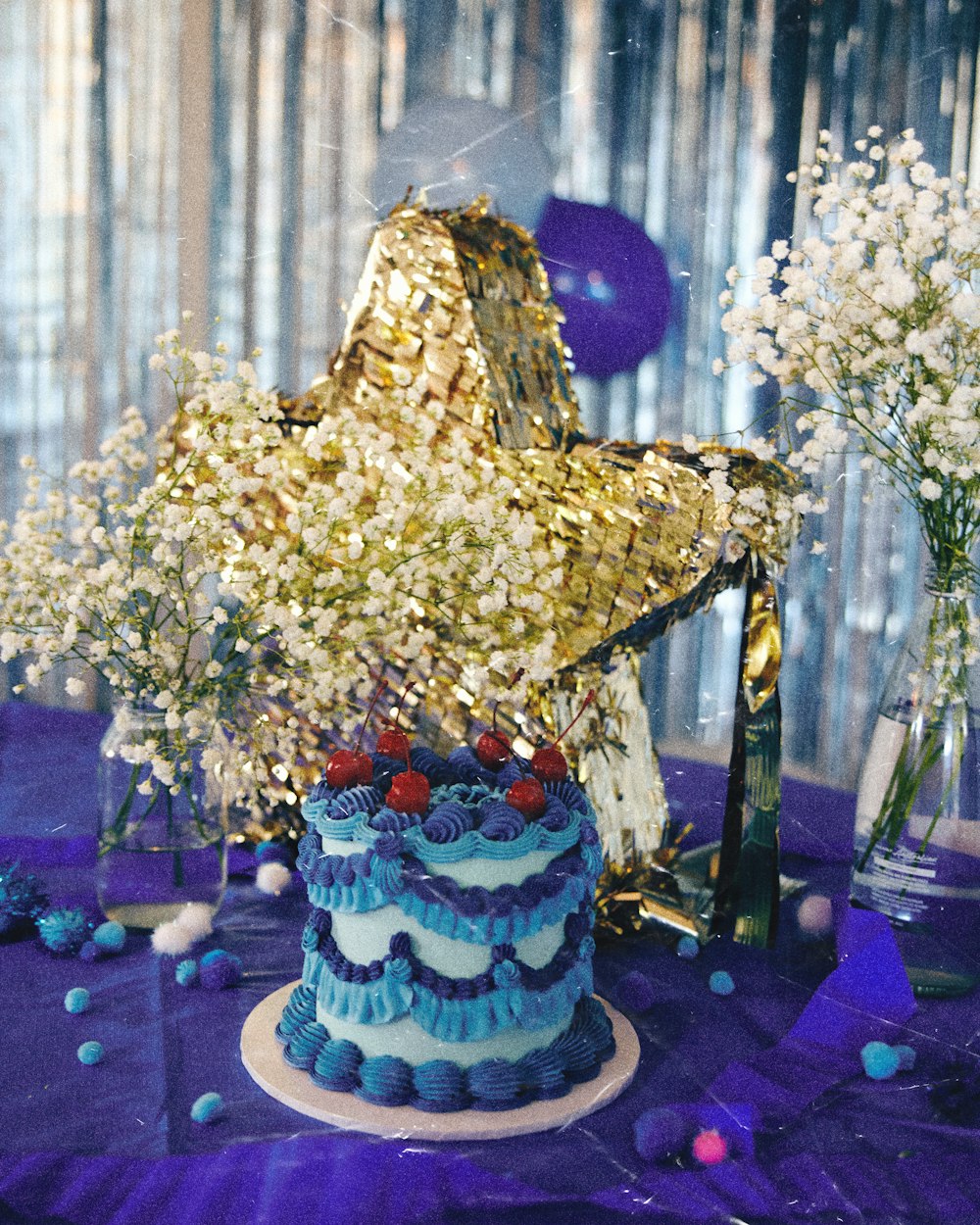 a blue and white cake sitting on top of a table