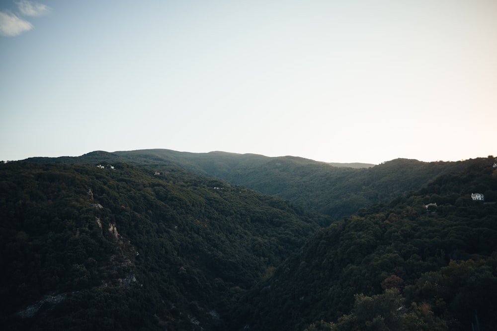 a view of a mountain range with a house in the distance