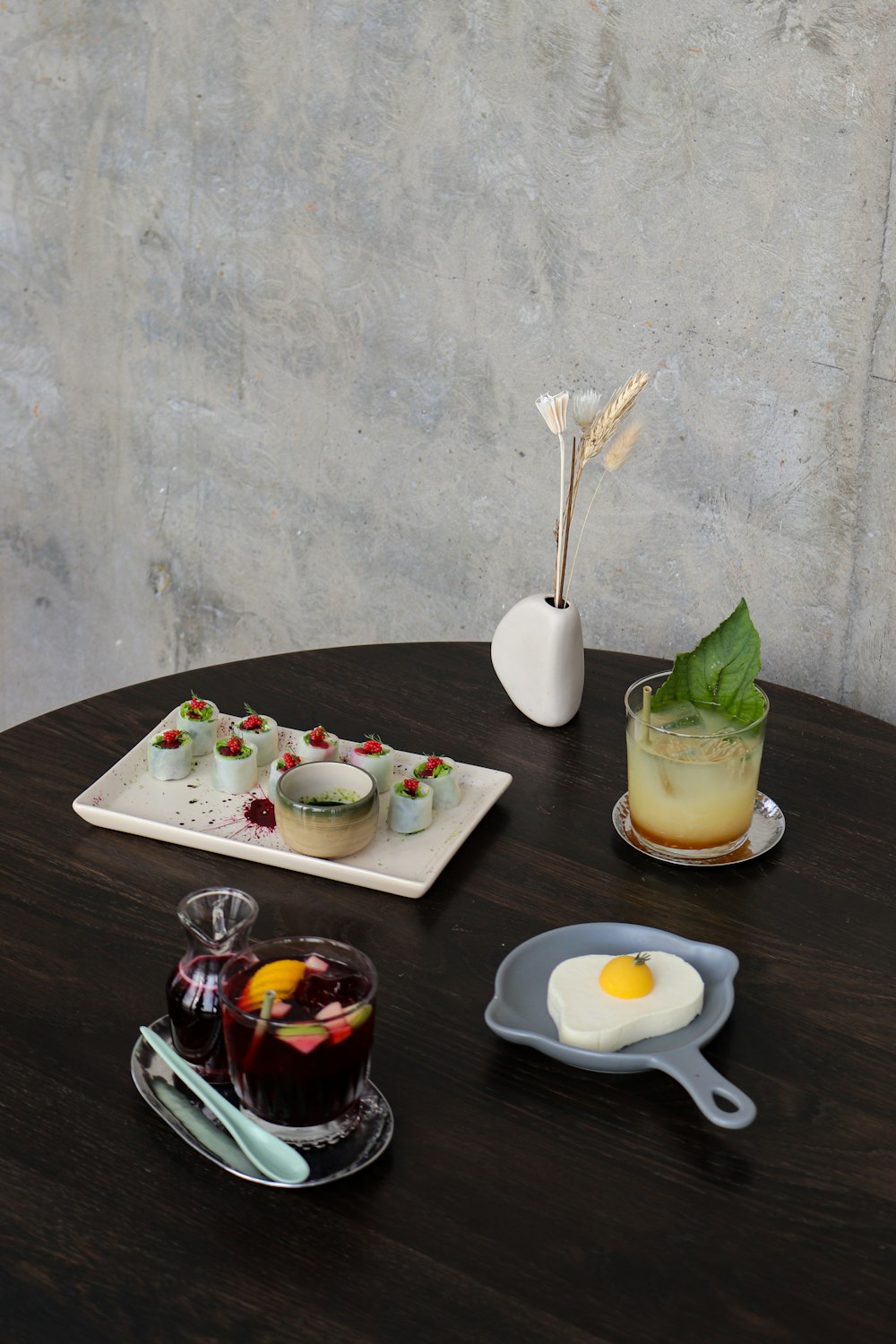 a table topped with a plate of food and a drink