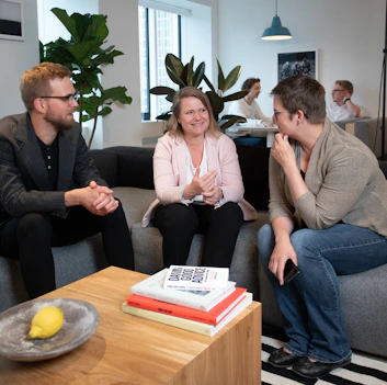 a group of people sitting around a living room together