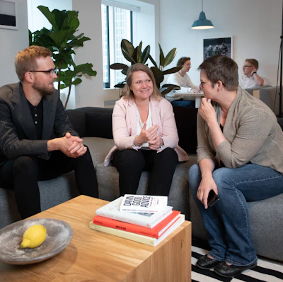 a group of people sitting around a living room together