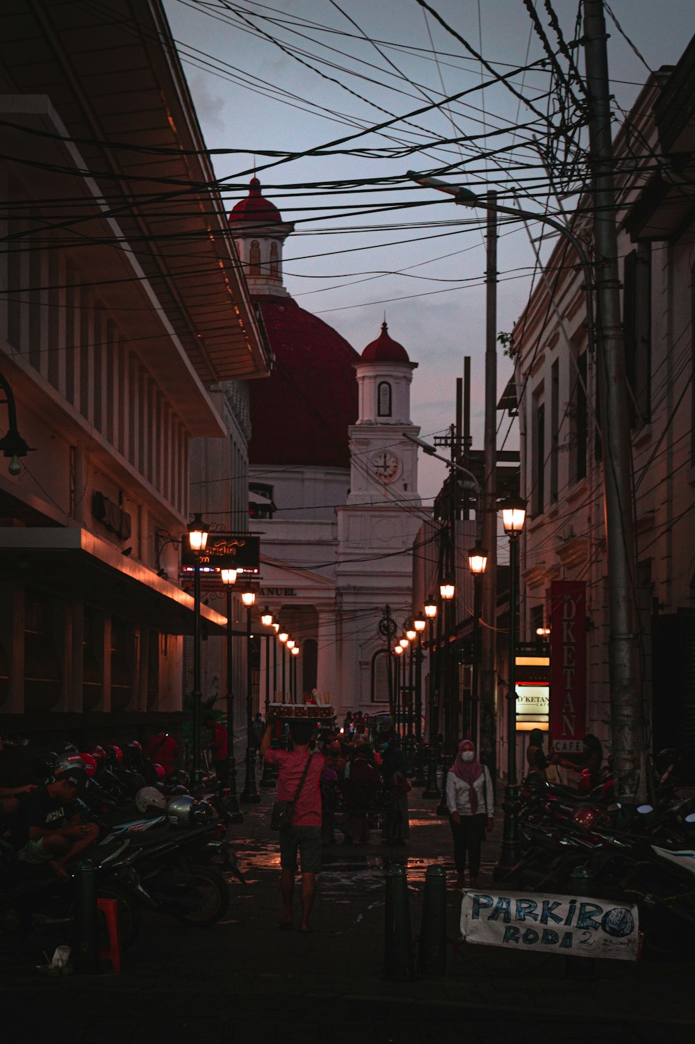 a city street with a church in the background