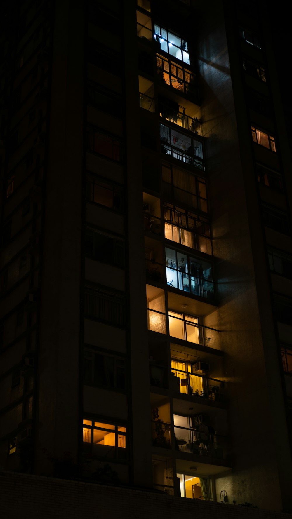 a tall building with many windows lit up at night