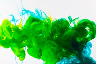 a mixture of green and blue ink in water motion graphics designer at work