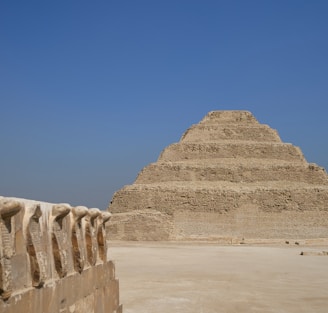 a very tall pyramid sitting in the middle of a desert