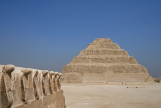 a very tall pyramid sitting in the middle of a desert