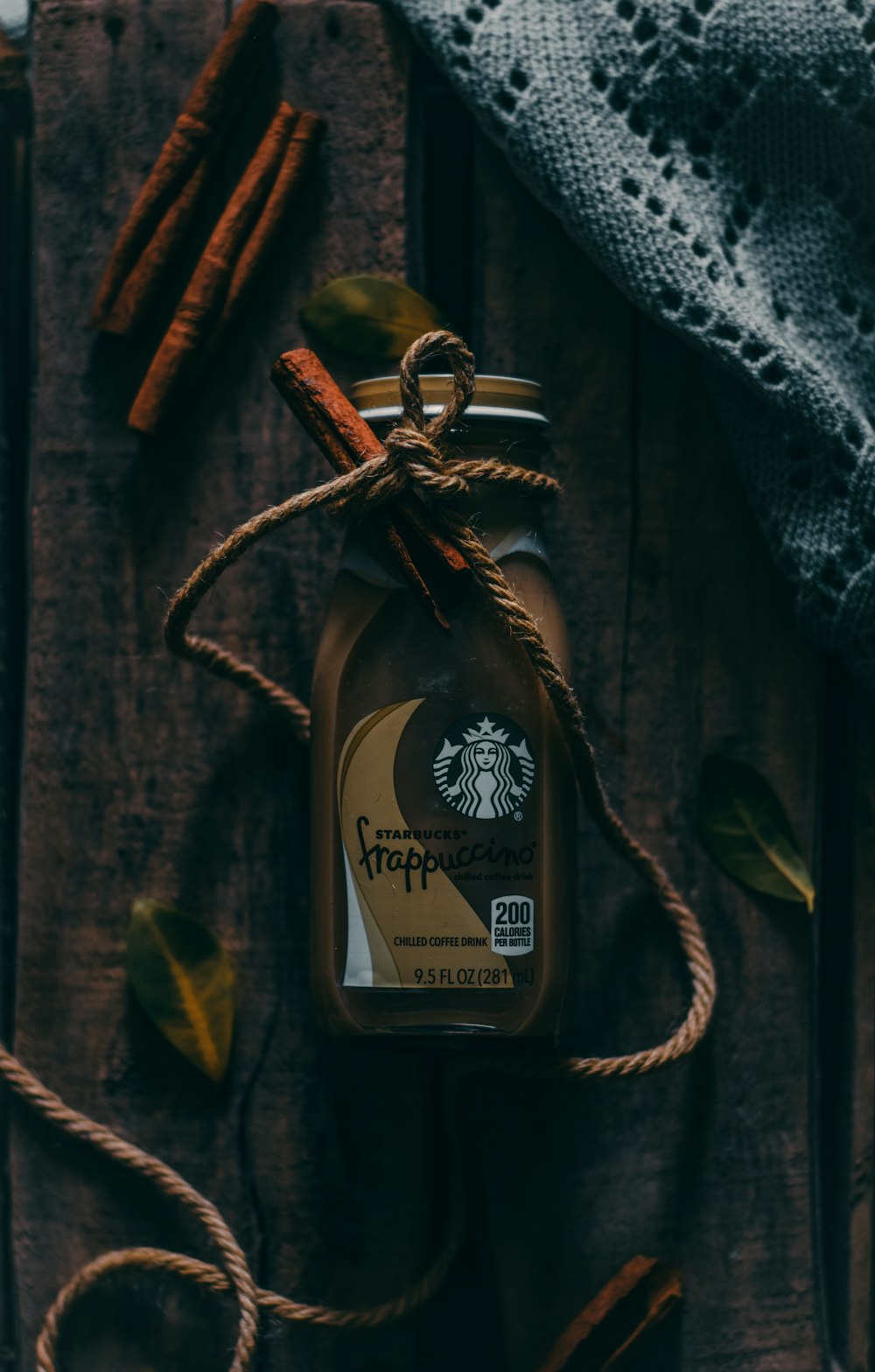 a bottle of coffee sitting on top of a wooden table