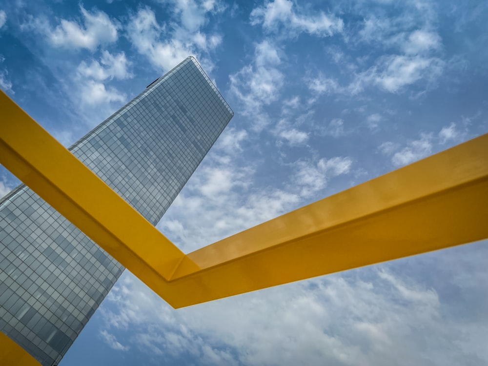 a tall building sitting next to a tall yellow pole