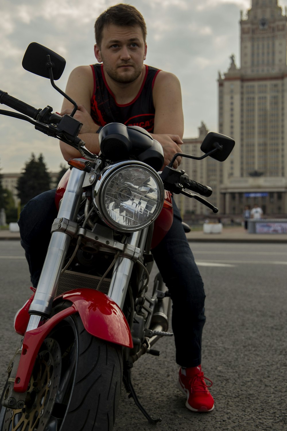 a man is sitting on a motorcycle on the street