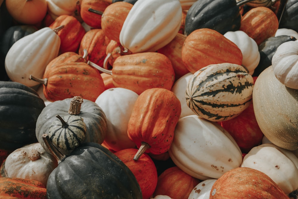 a pile of pumpkins sitting next to each other