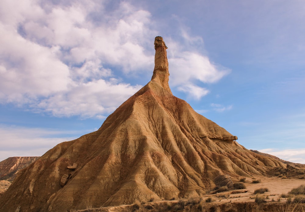 a large rock formation in the middle of a desert