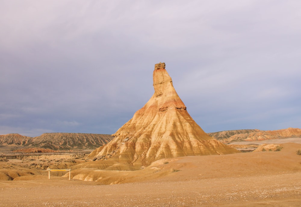 a large rock formation in the middle of a desert