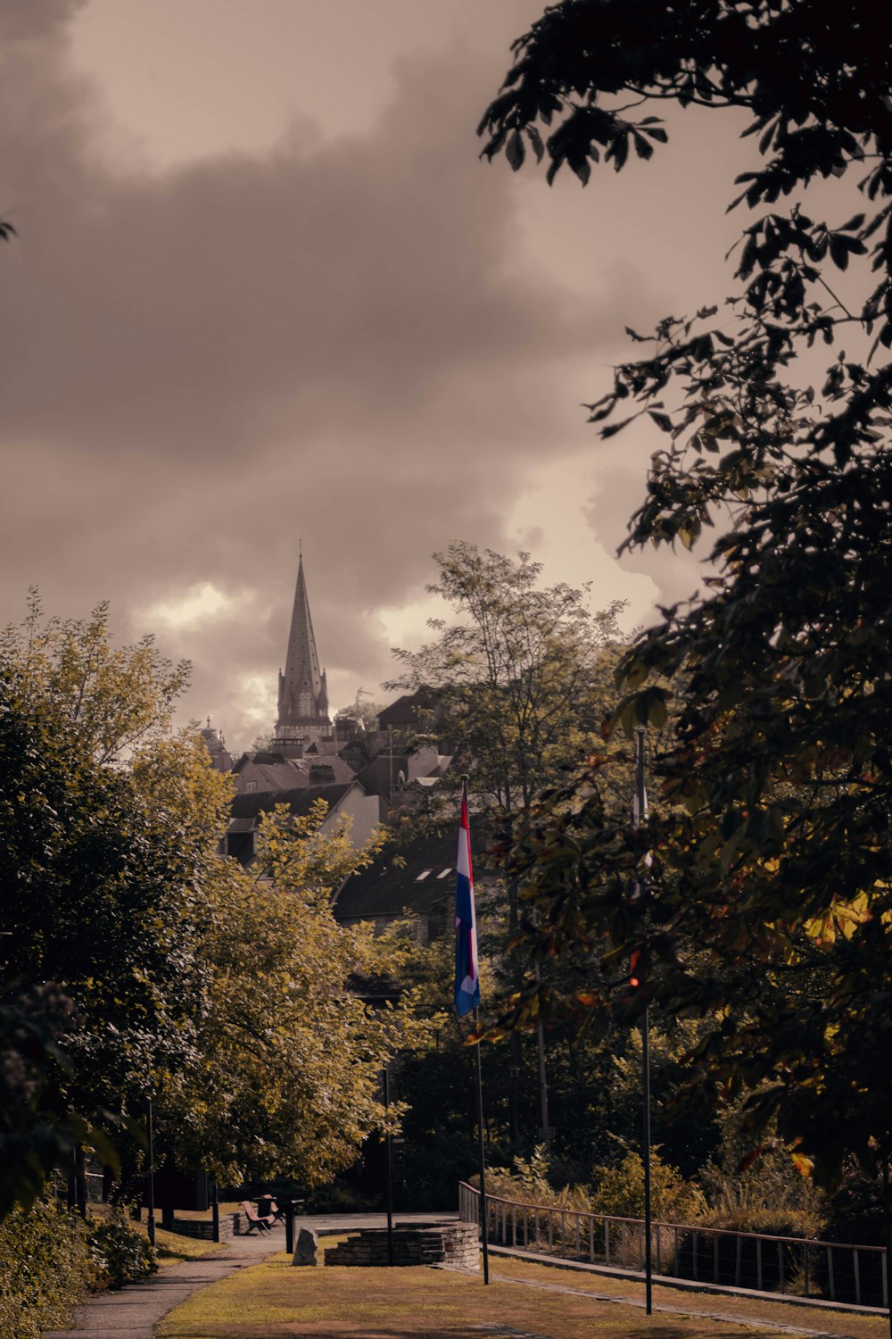 a view of a park with a church in the background