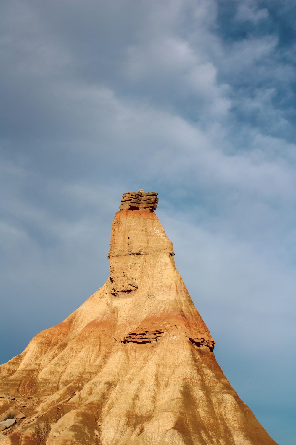 a very tall mountain with a sky in the background