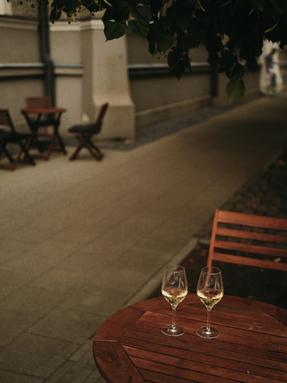 two glasses of wine sitting on a wooden table