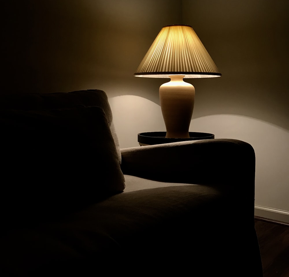 a lamp on a table next to a couch