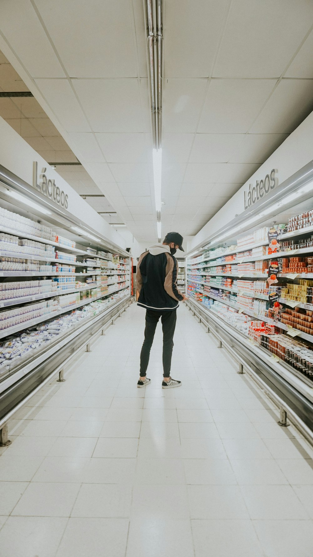 a person standing in a grocery store aisle