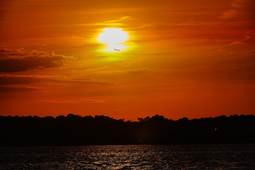 the sun is setting over a body of water