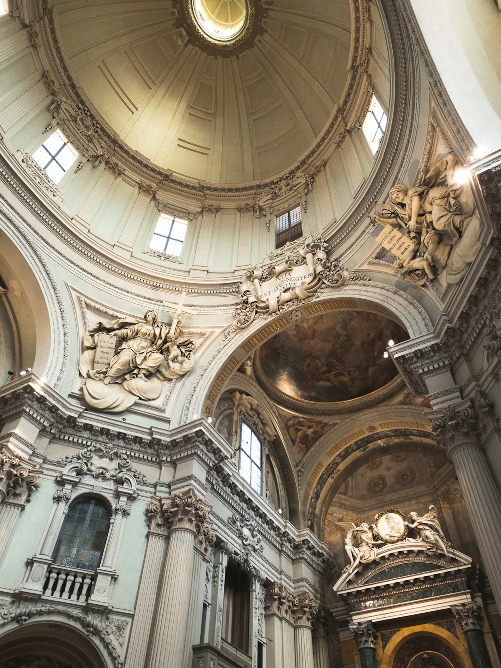 a church with a dome ceiling and statues on the walls