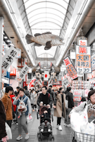 A bustling scene at Kuromon Market in Osaka, with fresh seafood and vibrant local produce on display.
