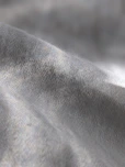 a close up of a gray fabric with a blurry background